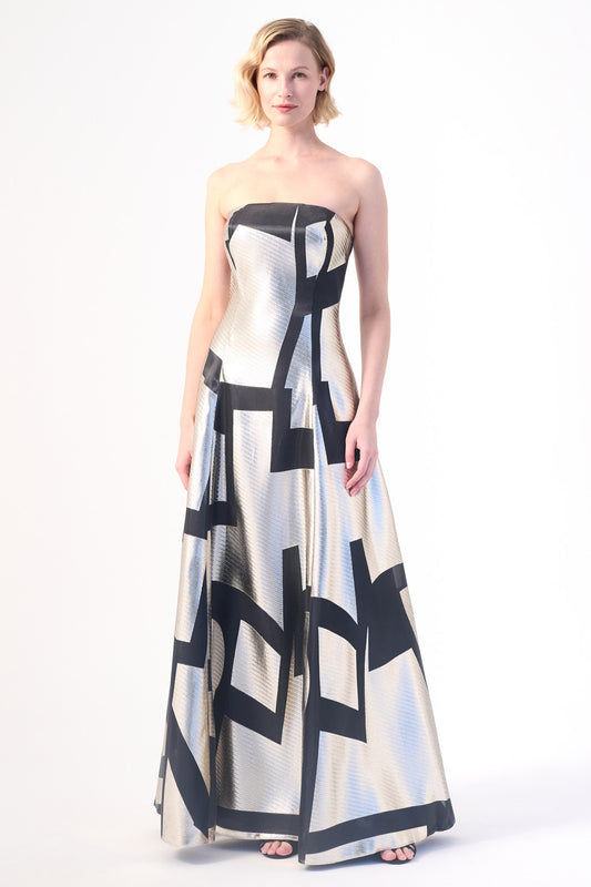 A strapless evening gown with a metallic silver base and bold black geometric patterns