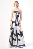 A strapless evening gown with a metallic silver base and bold black geometric patterns