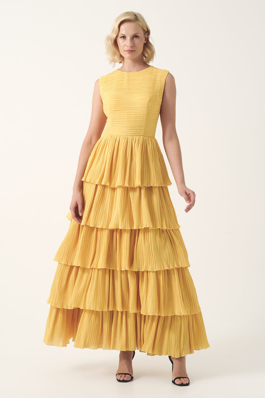 Sleeveless circle neckline with a fitted pleated bodice and layered pleated gown