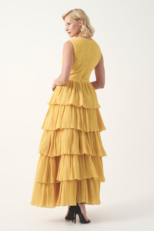 Sleeveless circle neckline with a fitted pleated bodice and layered pleated gown